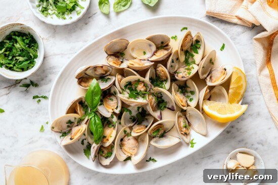 Tender Steamed Clams with Garlic and White Wine 10 Platter of steamed clams with basil.