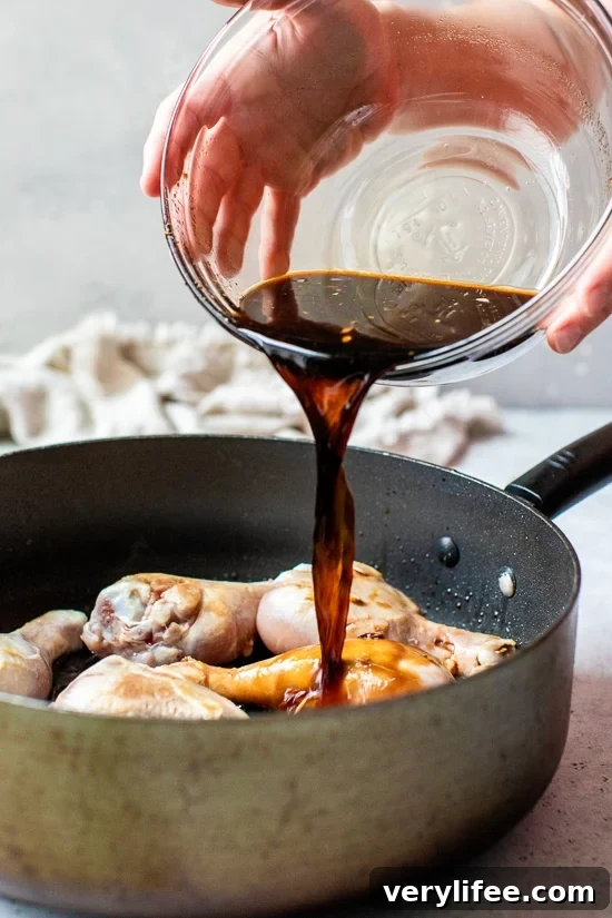 Sticky Asian Glazed Chicken Drumsticks Recipe 4 Pouring soy sauce and vinegar over chicken drumsticks