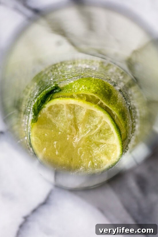 Muddle the limes, mint and sugar.
