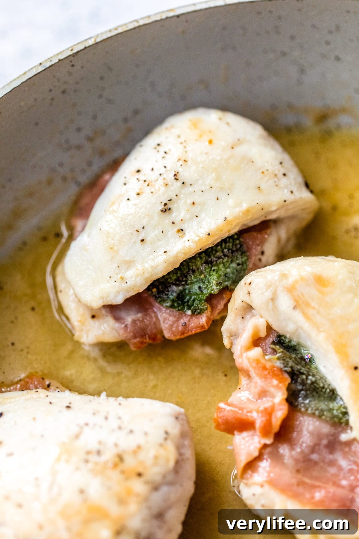 Lightened up chicken saltimbocca cooking in skillet
