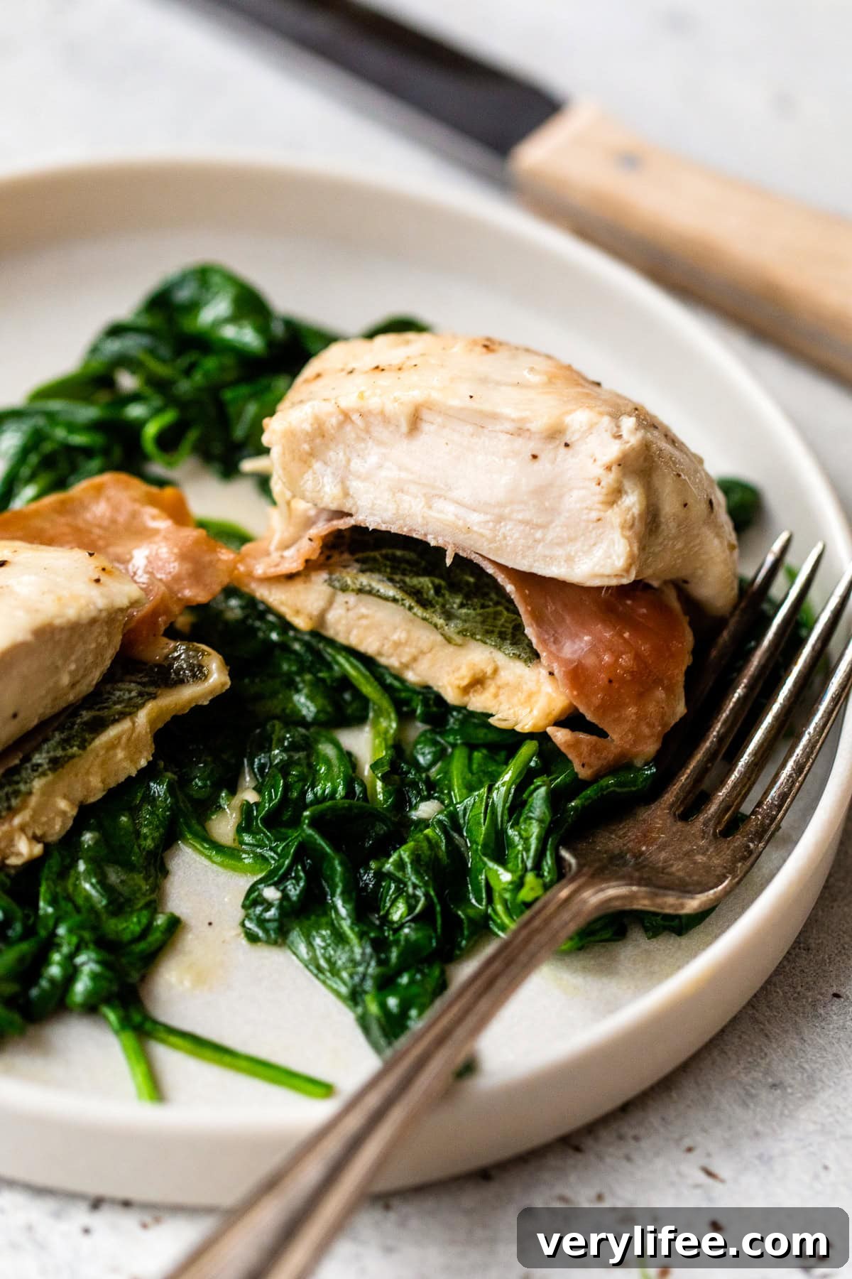 Chicken Saltimbocca with spinach on plate