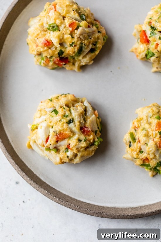 Shape the crab cakes Chilled crab cake patties on a plate.