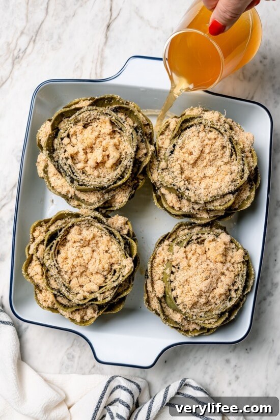 Garlic-Parmesan Stuffed Artichokes Recipe 6 Overhead view of stuffed artichokes in baking dish before baking
