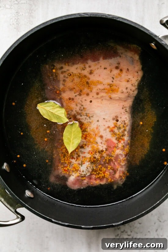 Corned Beef and Cabbage with Creamy Horseradish Sauce 5 Corned Beef and bay leaves in a pot