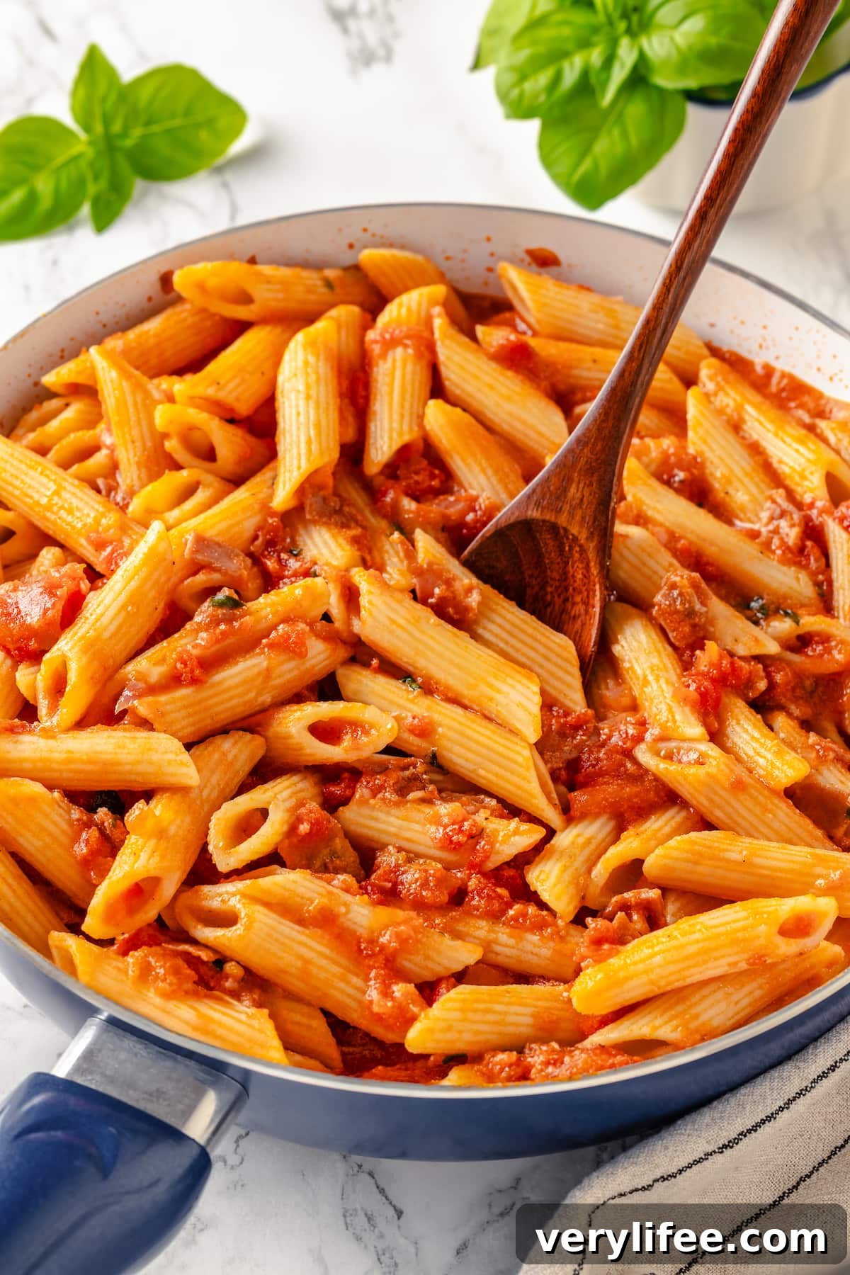 A fork in a bowl of penne alla vodka