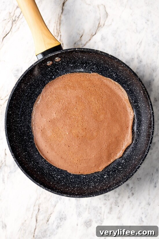 Chocolate crepe in skillet.