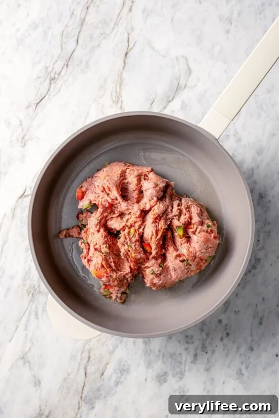 Turkey sausage added to pot with olive oil.