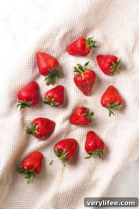 Dry the strawberries Strawberries drying on white kitchen towel