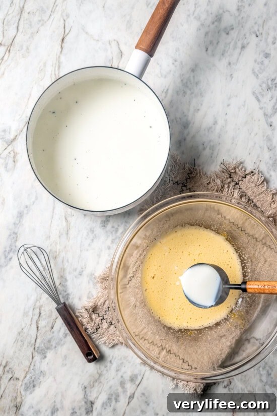 Overhead view of warm milk in pan and egg mixture in bowl