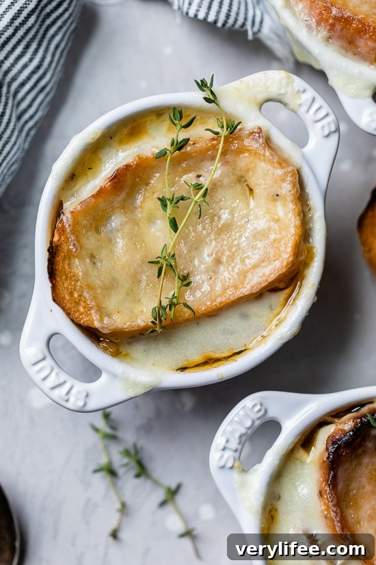 Overhead view of French onion soup in ramekins.