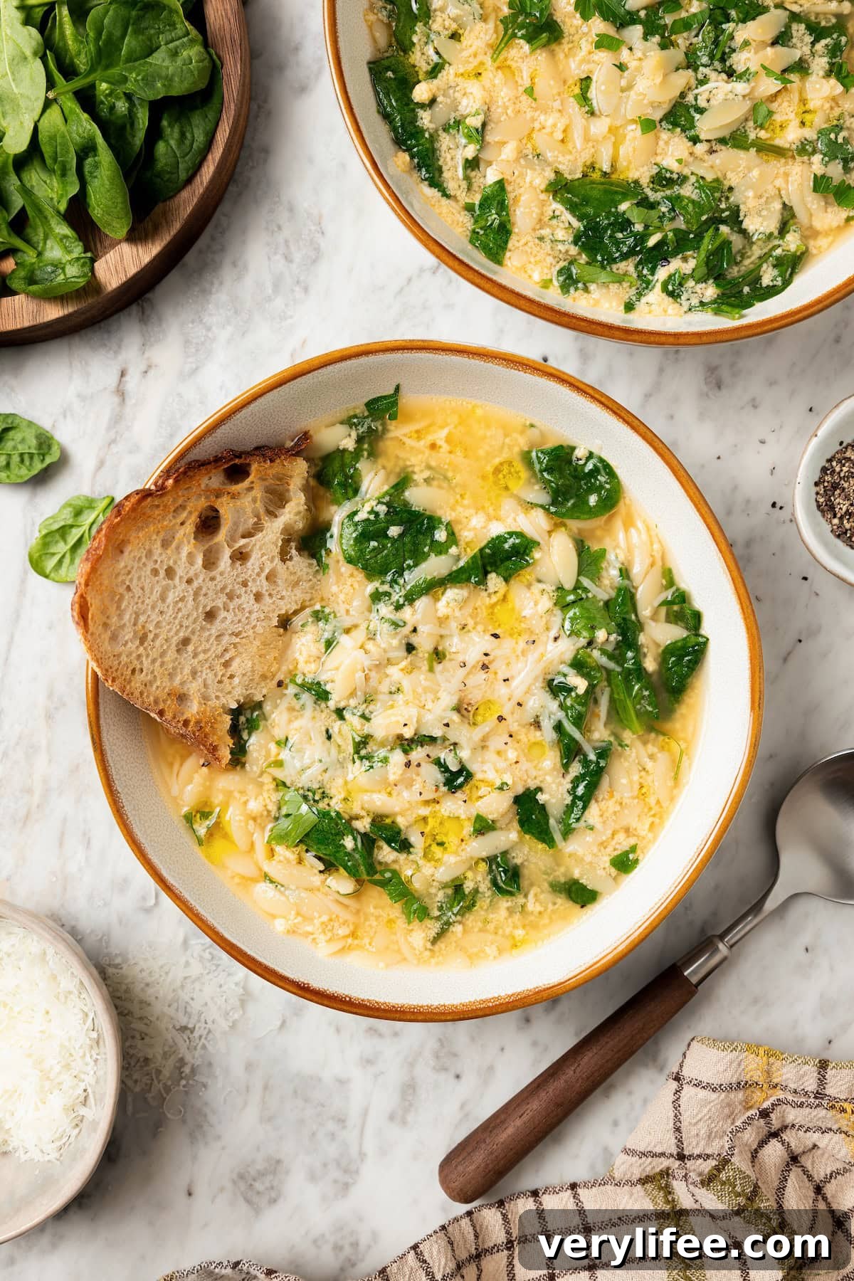 Classic Italian Stracciatella Soup with Spinach and Orzo 9 Two bowls of stracciatella soup with orzo and spinach.