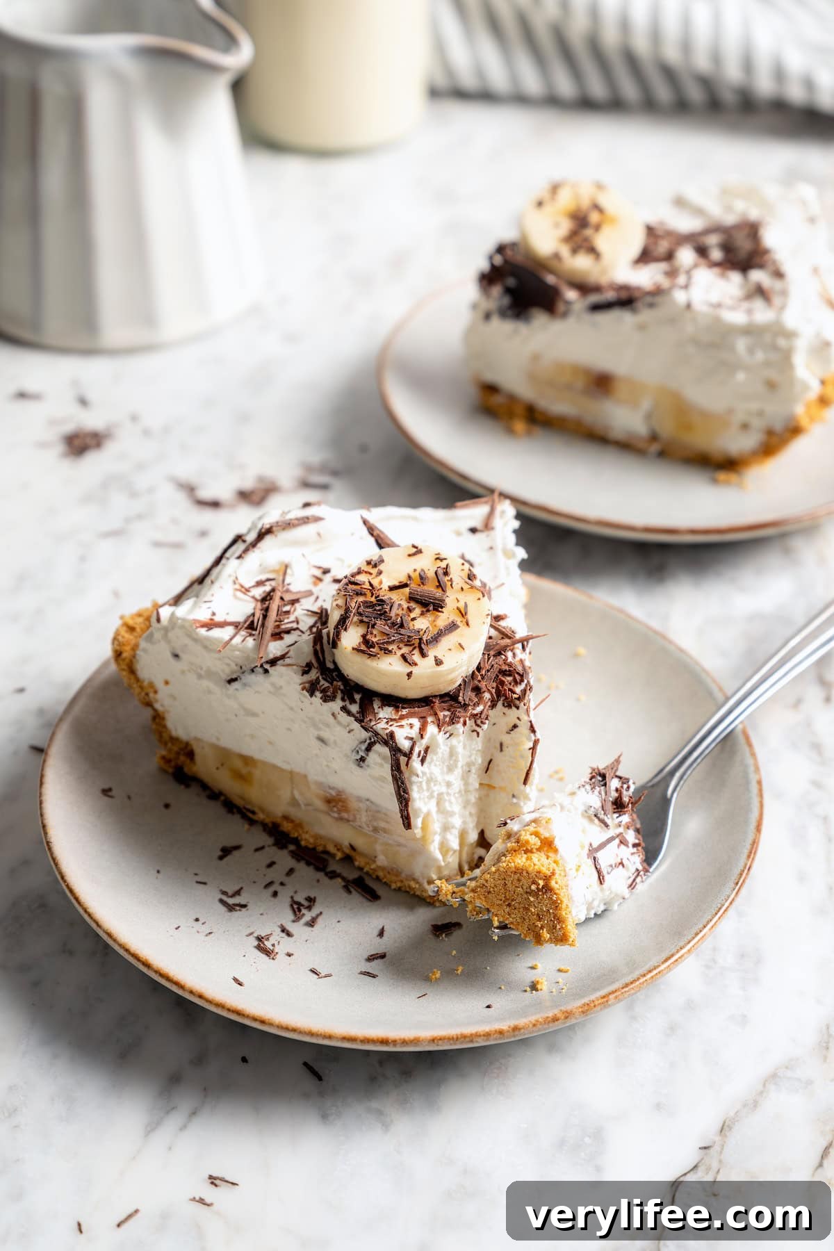 No-Bake Banana Cream Pie Recipe 11 Slice of banana cream pie on plate with tip of pie on fork.