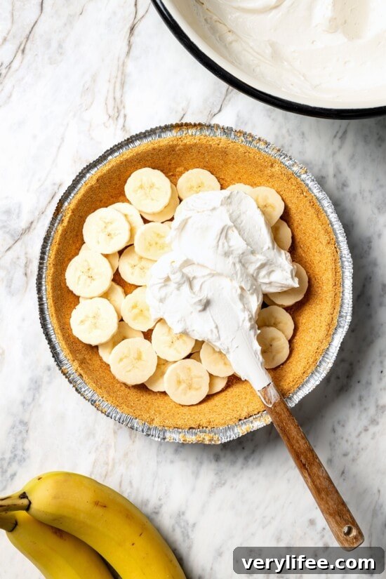 No-Bake Banana Cream Pie Recipe 8 Adding banana cream pie filling to crust.