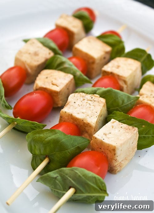 Mozzarella, basil and tomato skewers on a platter