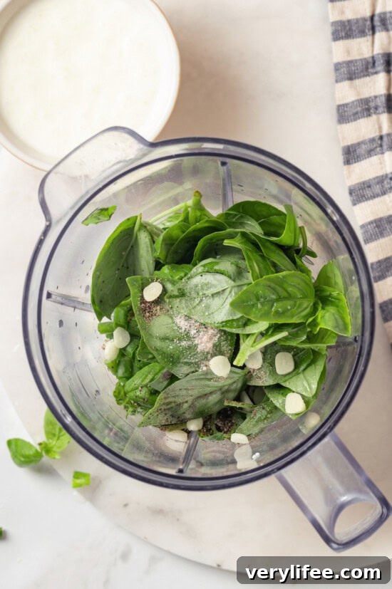 Overhead view of ingredients for basil green goddess dressing added to blender