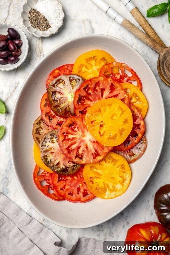 Overhead view of sliced heirloom tomatoes on platter