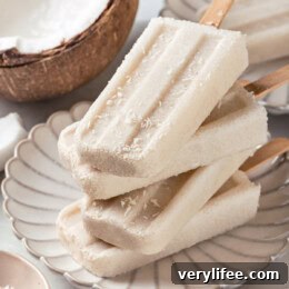 Creamy Coconut Popsicles Recipe 3 Four coconut popsicles stacked on plate