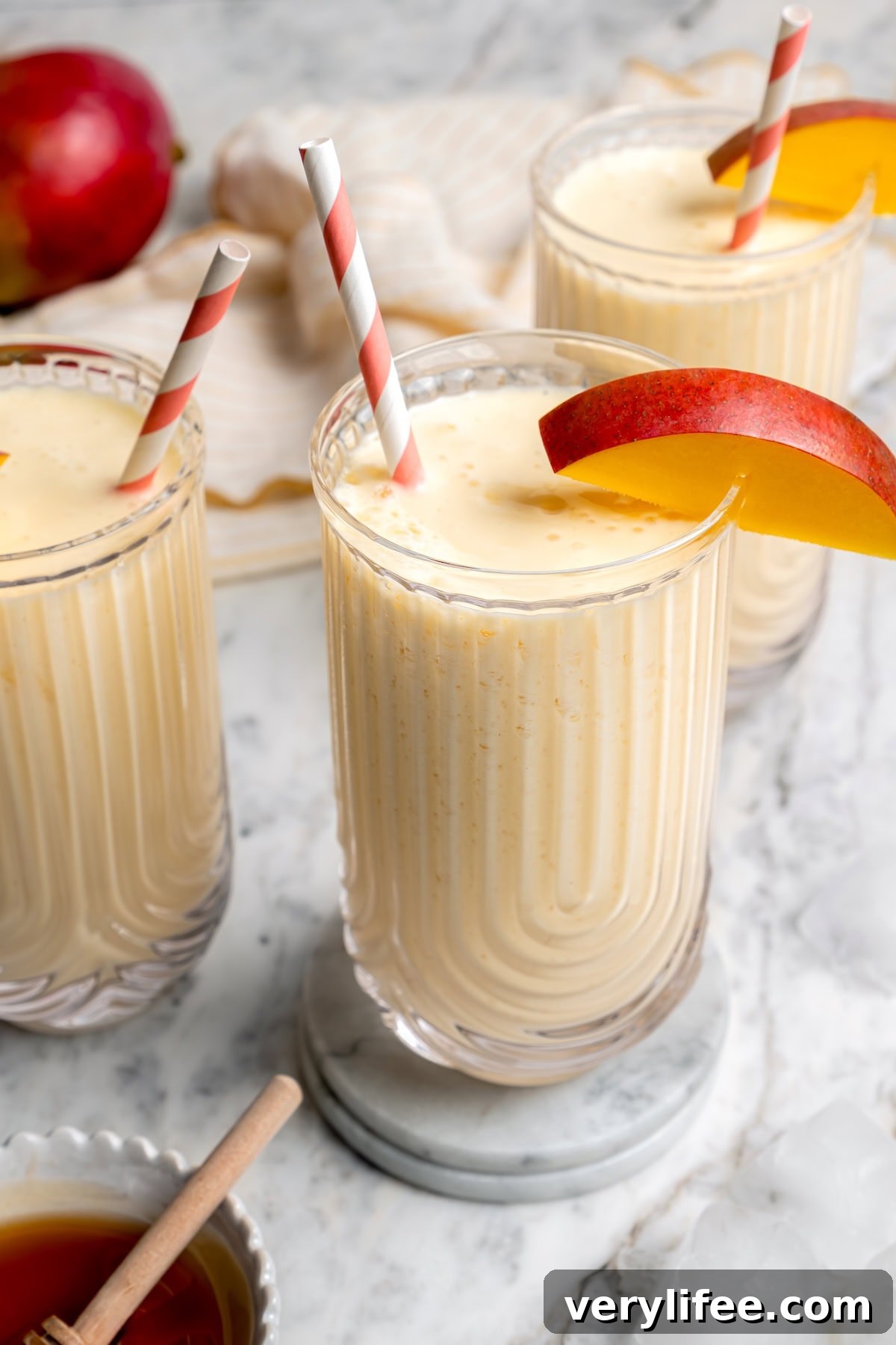 3 glasses filled with homemade mango lassi