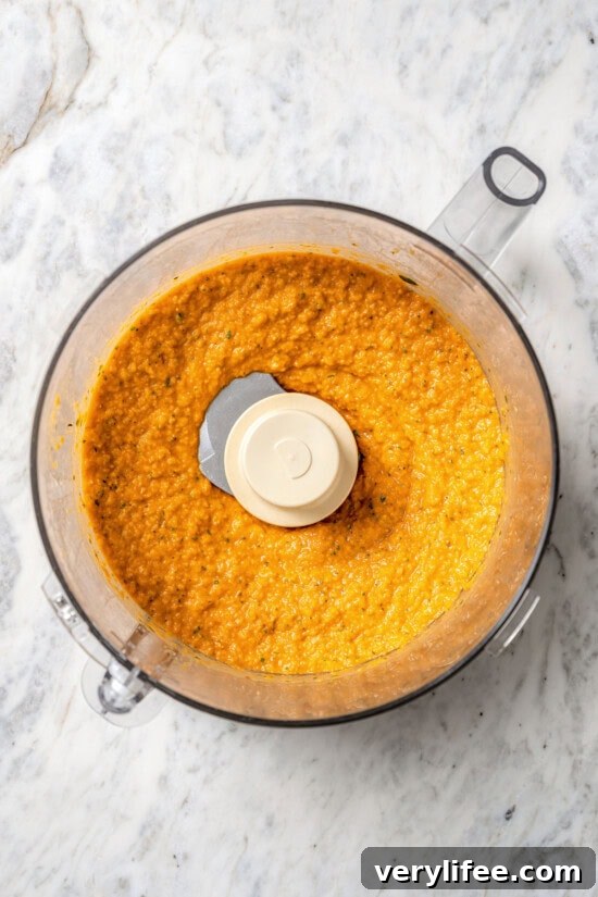 Overhead view of roasted red pepper hummus in food processor