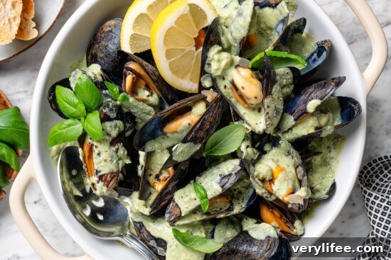 Creamy Basil Mussels Recipe 10 Bowl of mussels with basil cream sauce.