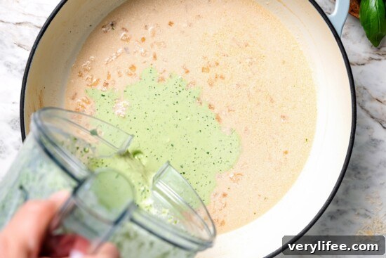 Creamy Basil Mussels Recipe 9 Pouring basil cream sauce into pan.