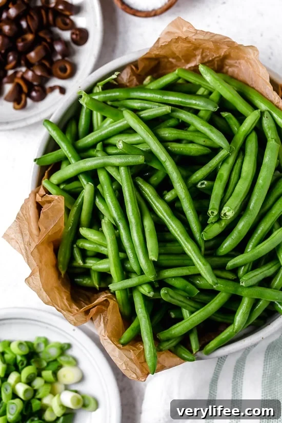 Green beans in parchment-lined bowl.