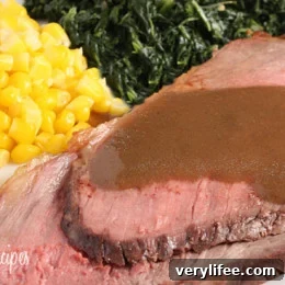 Roast beef on a platter with gravy