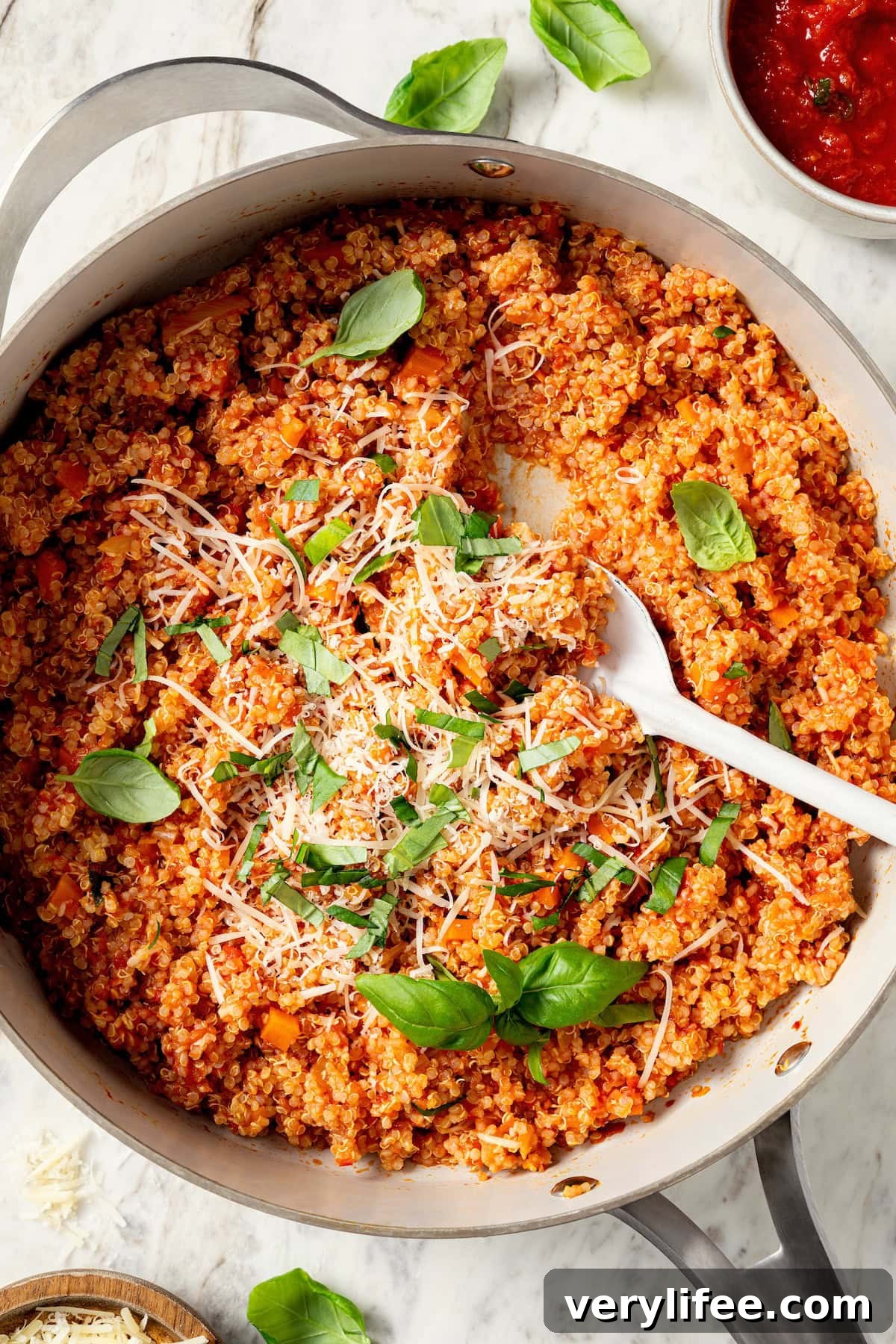 Skillet of quinoa risotto with serving spoon.