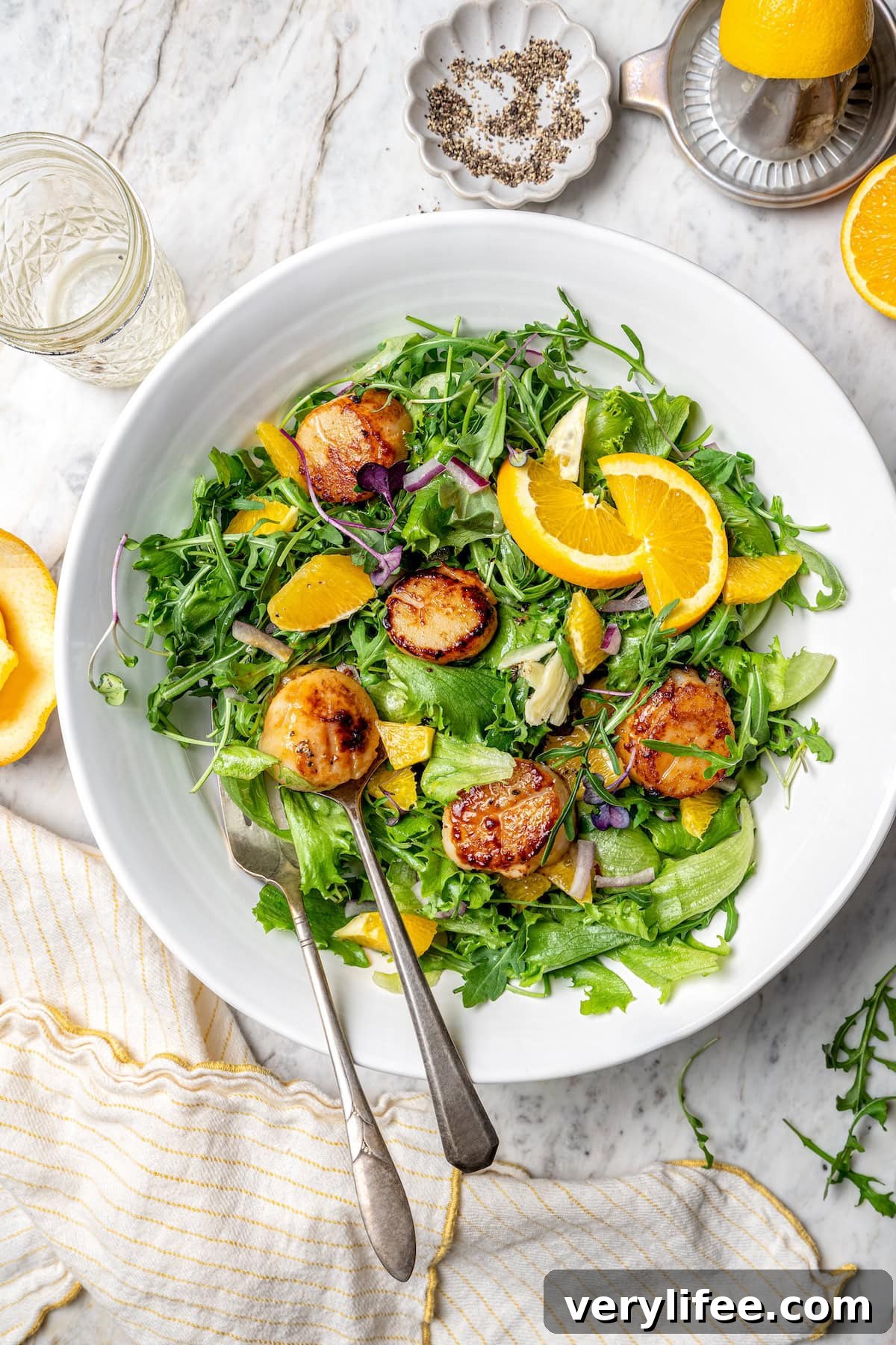 Pan seared scallops in serving bowl with citrus salad