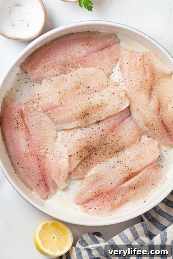 Crispy Oven Baked Tilapia with Lemon and Herbs 3 Tilapia in baking dish