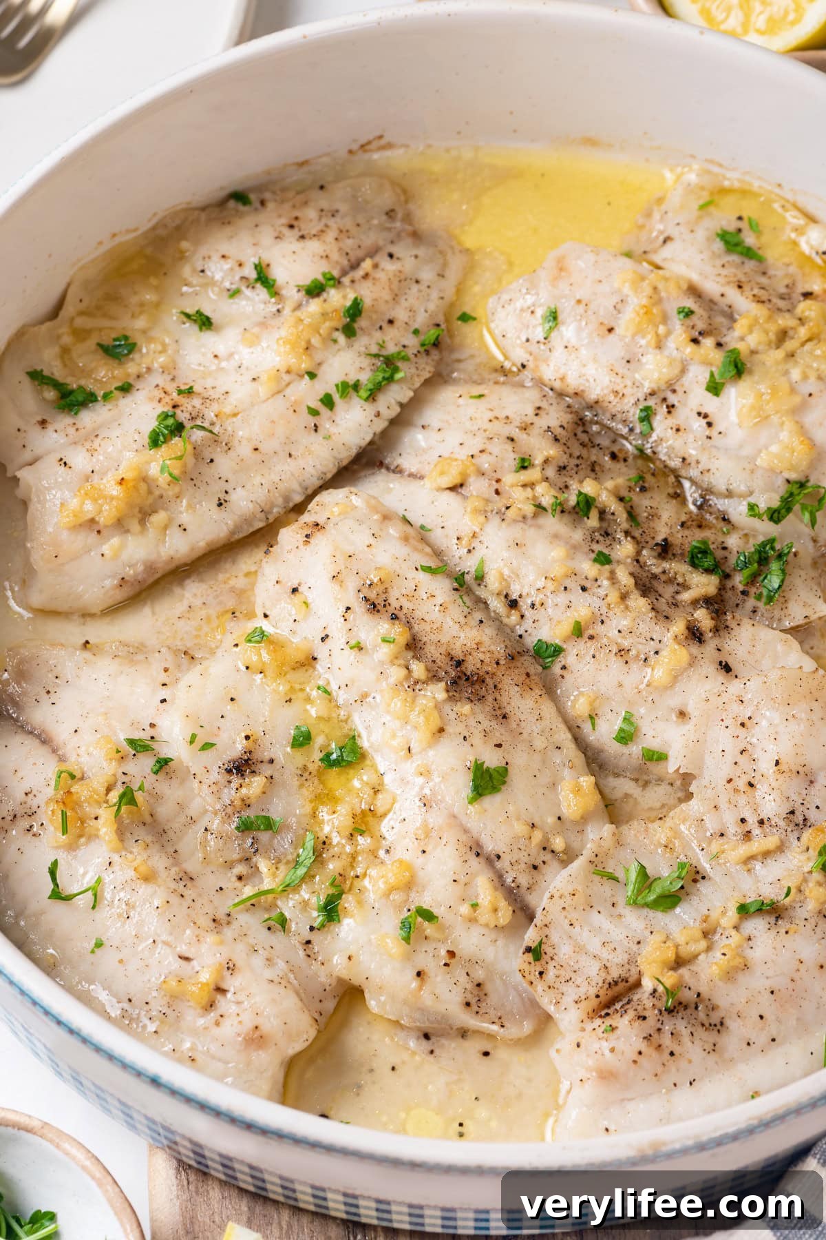 Crispy Oven Baked Tilapia with Lemon and Herbs 6 Healthy baked tilapia in pan