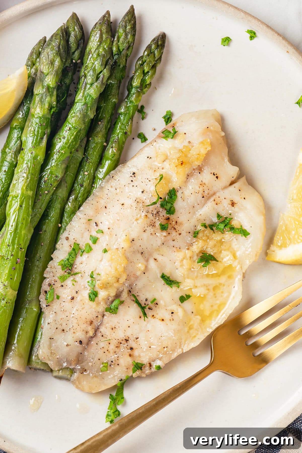 Crispy Oven Baked Tilapia with Lemon and Herbs 7 Easy baked tilapia on plate with asparagus