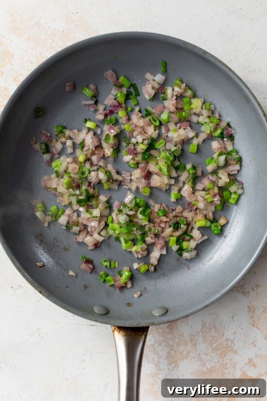 skillet with scallions and red onion