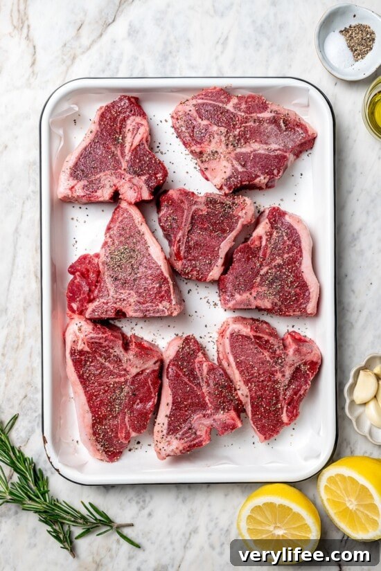 Grilled Rosemary Lamb Chops Recipe with Garlic and Lemon 7 Overhead view of seasoned lamb chops in pan