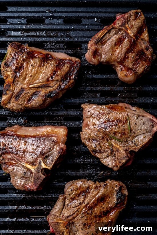 Grilled Rosemary Lamb Chops Recipe with Garlic and Lemon 9 Overhead view of grilled lamb chops on grill pan