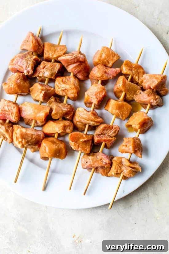 Thread the pork onto the skewers.
