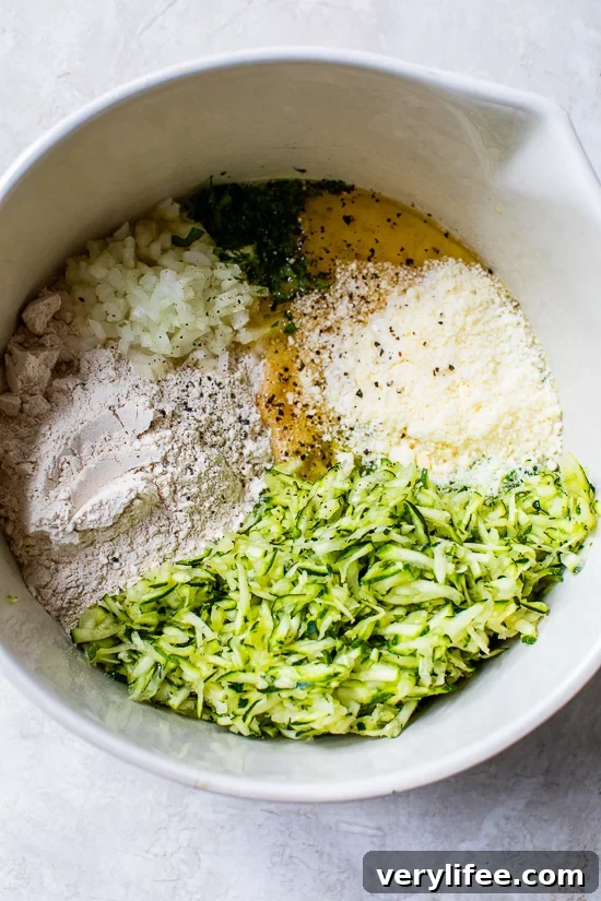 grated zucchini, Parmesan cheese, Bisquick, and egg in a bowl