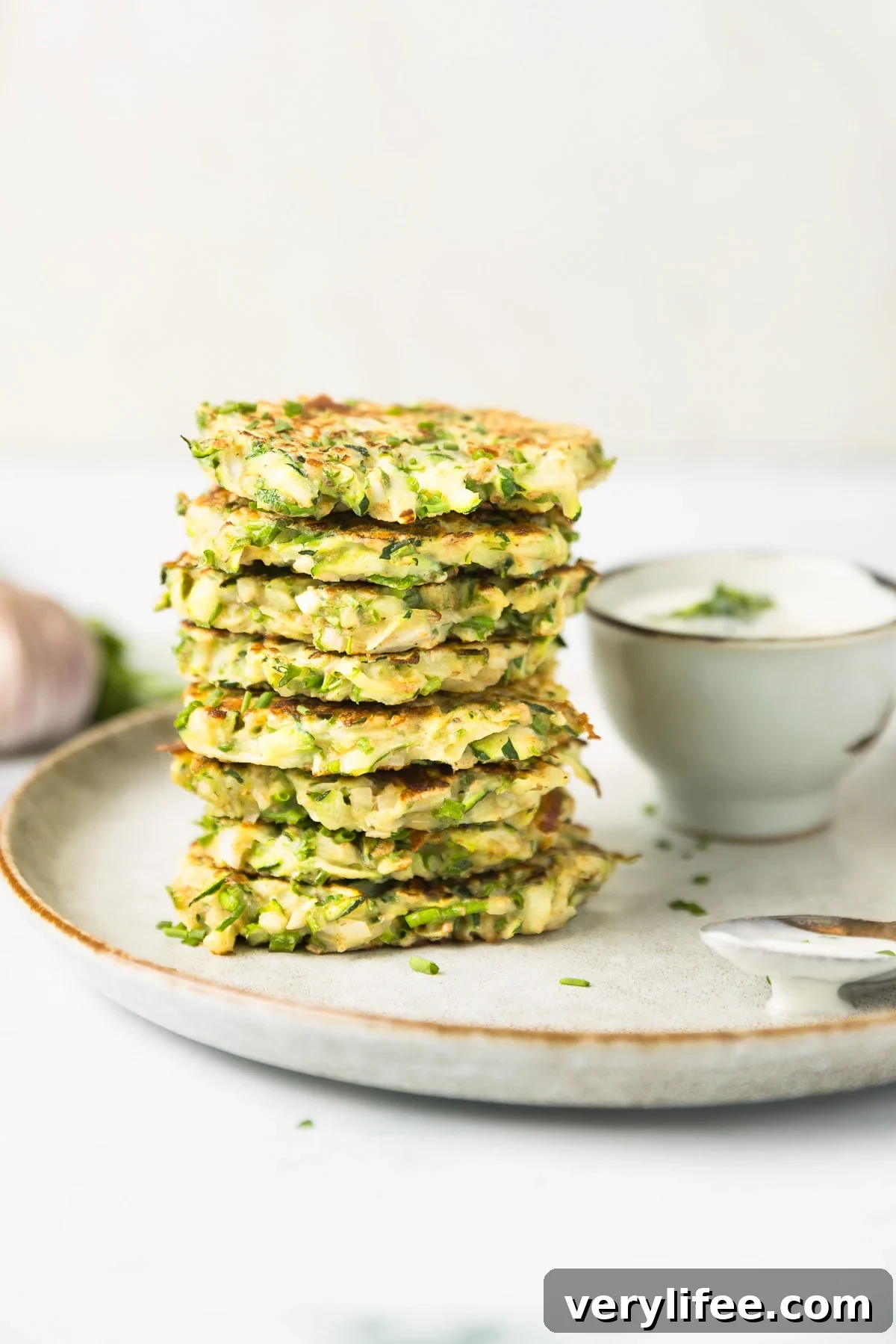 A stack of crispy zucchini pancakes on a plate.