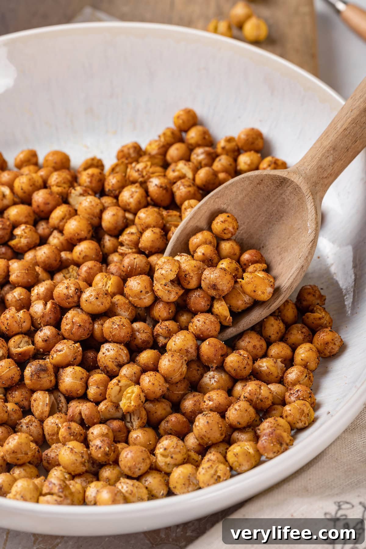 Crispy Roasted Chickpeas Recipe 7 Scooping roasted chickpeas from bowl