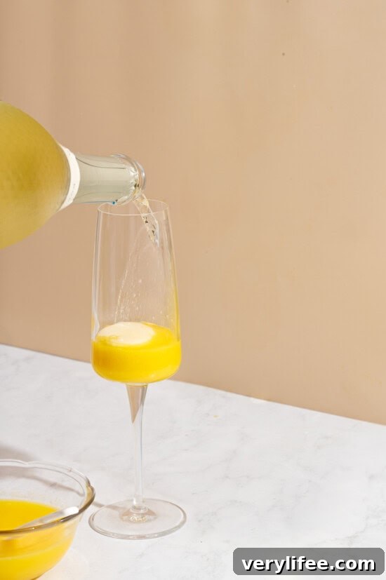 pouring prosecco into glass