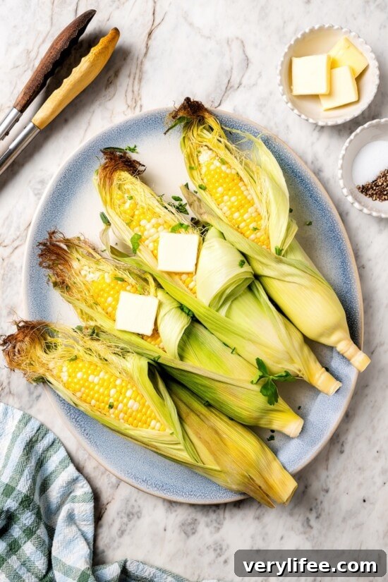 How to Cook Corn on the Cob in the Microwave 6 Platter with microwave corn on the cob topped with butter.