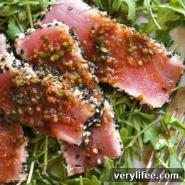 Seared Sesame-Crusted Tuna Steak over Arugula 5 Sesame Crusted Tuna Steak on Arugula drizzled with a balsamic soy-ginger vinaigrette – yum!