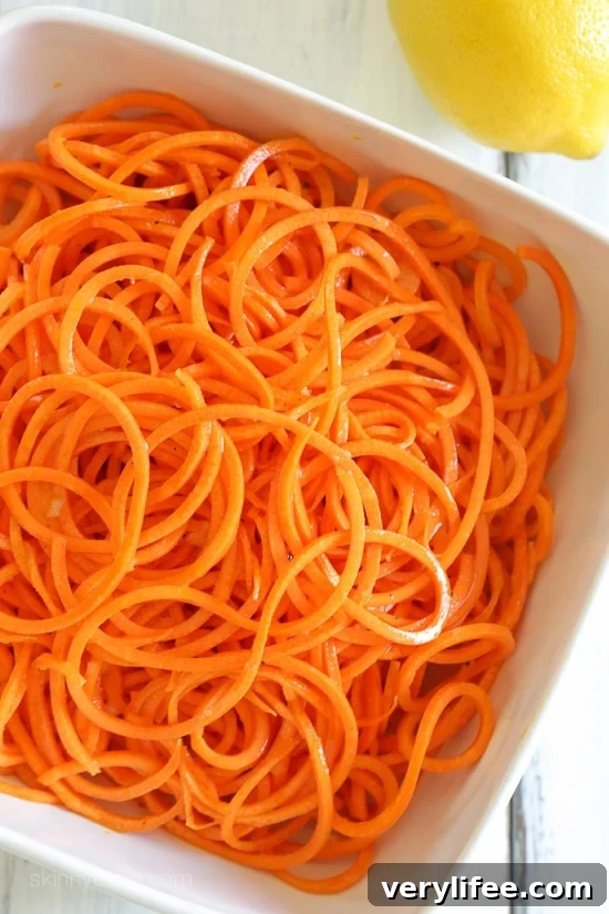 An easy 5-ingredient carrot salad that is lemony, bright and delicious! You don't need a spiralizer to make it, you can use pre-shredded carrots or use a potato peeler to cut the carrots into ribbons.