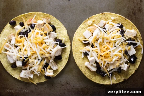 Crispy Nacho-Style Chicken Tostada with Melted Cheese 5 Tostada assembled with chicken, beans, cheese and fresh salsa.