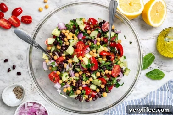 Garbanzo bean Mediterranean salad in glass mixing bowl.