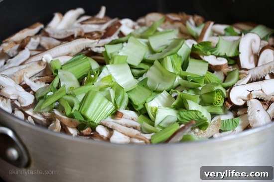 Mushrooms and bok choy in a pan.