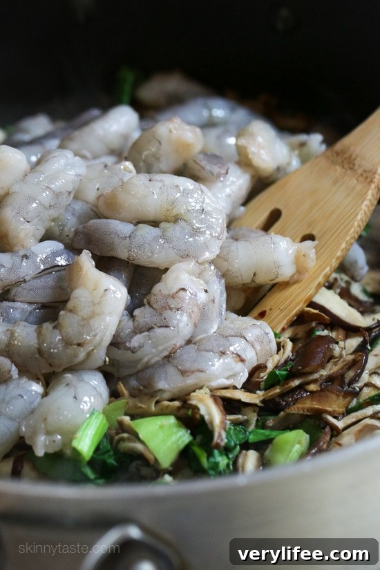 Raw shrimp added to the stir fry.