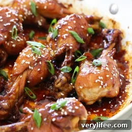 Honey Teriyaki Drumsticks plated, garnished with sesame seeds and scallions