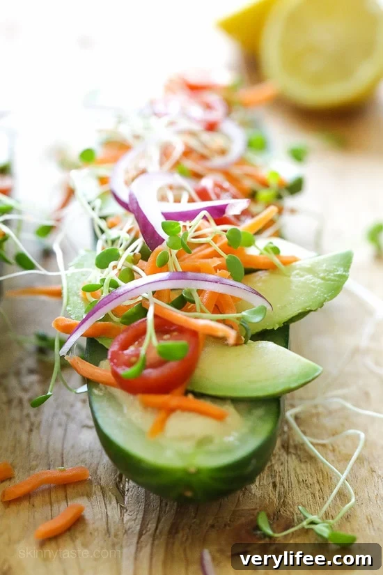 Cucumbers with the seeds scooped out and filled with hummus, avocado, tomatoes, onion and sprouts. So refreshing, healthy and light!
