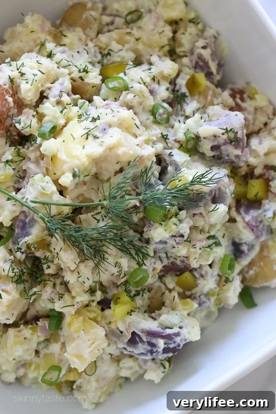 Creamy rainbow potato salad with rainbow potatoes, celery, pickles, mustard and dill